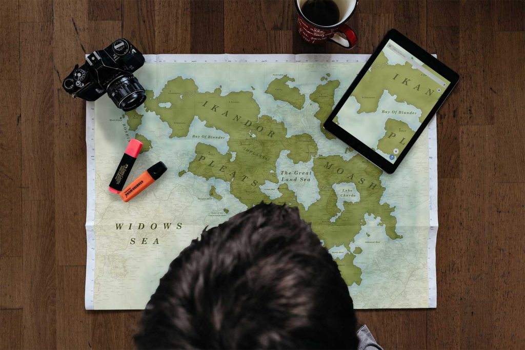 Picture of a boy looking over a fantasy map.